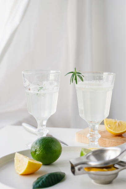 istock Lemon and lime citrus lemonade. Cooking process in a bright kitchen close-up 1454412830