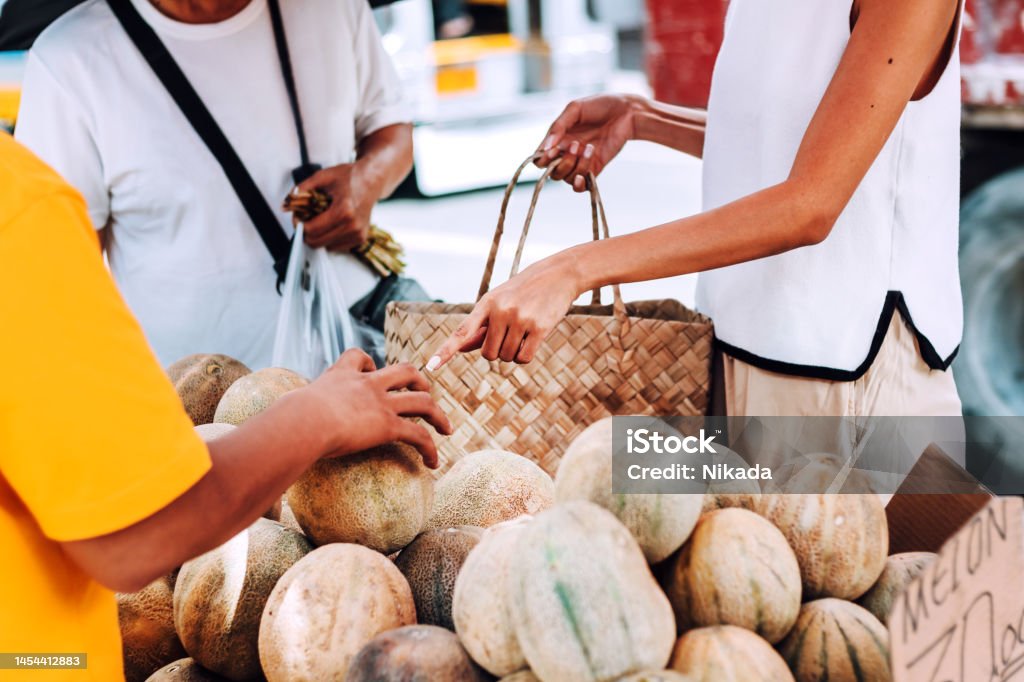 A Filipino street vendor selling fresh melons A Filipino street vendor selling fresh melons 
Manila, Philippines Makati Stock Photo