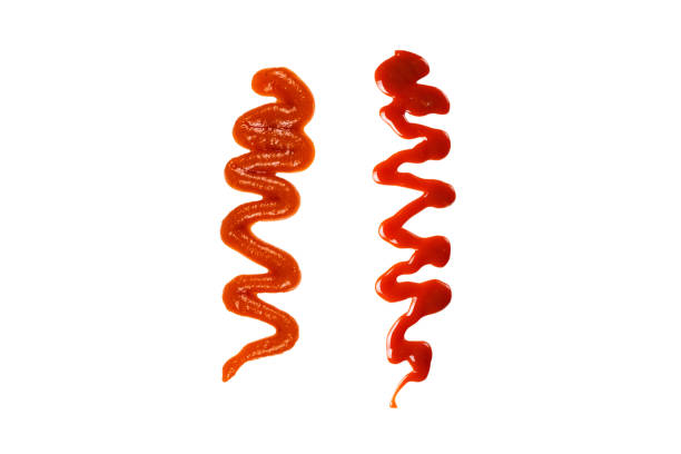 istock Orange sauce splashes isolated on white background 1454414630