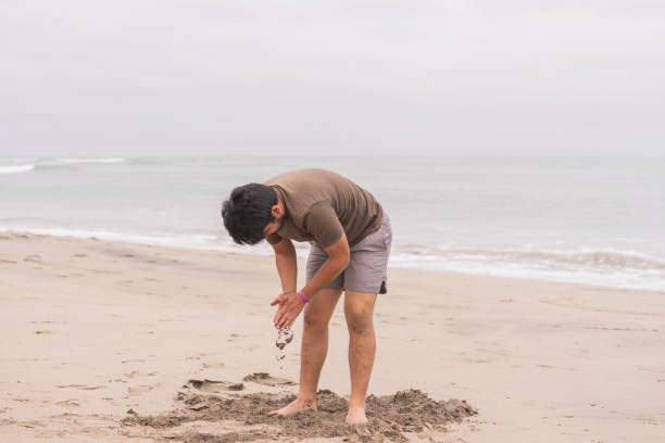 istock Young Hispanic man practicing various poses in yoga on the beach 1454415206