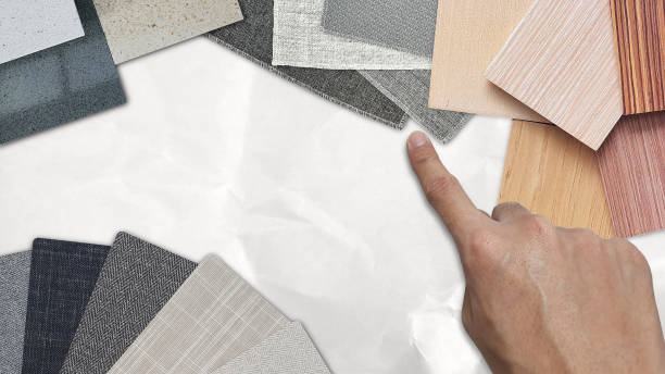 istock interior designer selecting material samples in various color scheme including fabric laminateds, drapery curtain fabrics, veneer wood, grainy stone tiles. moodboard, white crumple paper background. 1454416075