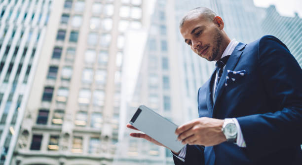 istock Successful entrepreneur browsing tablet in business district 1454417471