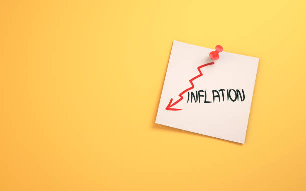 istock Low Inflation Lettering Written on Note Paper Sitting on Yellow Background 1454418043