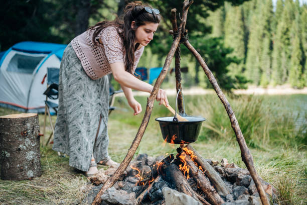 istock Woman cooking on the campfire. 1454419182