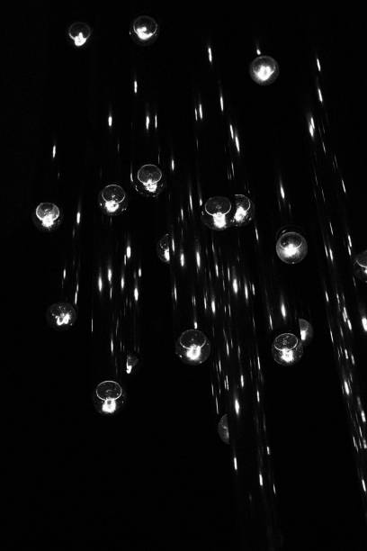 istock Chandelier with Multiple Light Bulbs. Monochromatic Black and White Tones 1454421393
