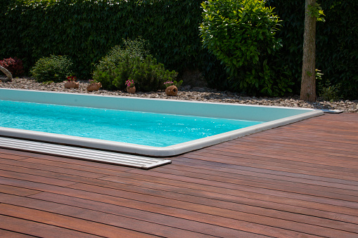 Swimming pool with teakwood flooring stripes summertime leisure ideas, teak wood decking