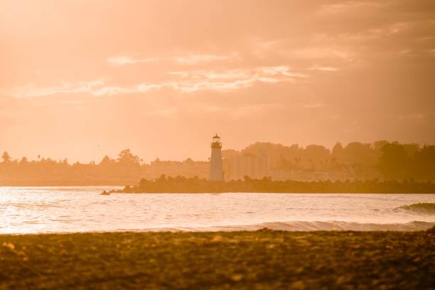 istock Lighthouse seen in the glowing sunset at a seashore 1454425634