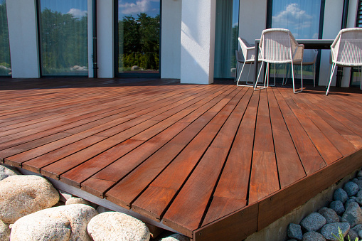 Wood deck, modern house design with wooden patio, low angle view of tropical hardwood decking