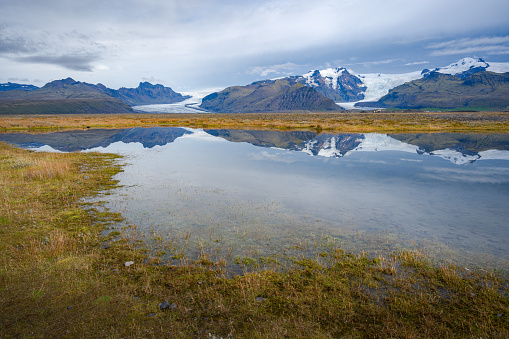 Vatnajokull Icelandic's volcanic landscape and it's glaciers in the distance. With the reflection in the water.