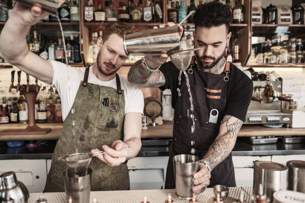 istock Two Young  barmen working at the bar 1454431571