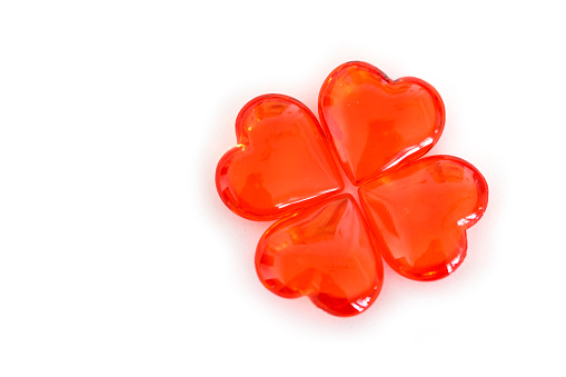 Red heart shape candy on white background.