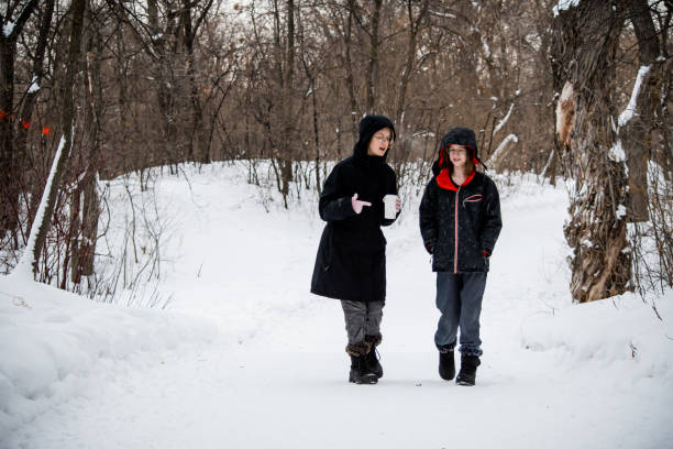 istock hiking and chatting sisters in winter 1454432628