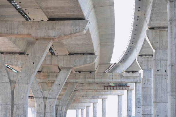 istock Flyover foundation posts structure under construction against white lacking sky in bangkok, Thailand 1454432720
