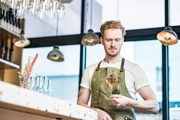 istock Young redhead barman working at the bar 1454432758