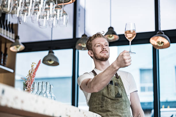 Young redhead barman working at the bar stock photo