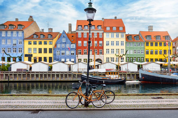 The popular Nyhavn area at Copenhagen, Denmark The popular Nyhavn area at Copenhagen, Denmark, with a street light and bicycles in front of the colorful houses nyhavn stock pictures, royalty-free photos & images