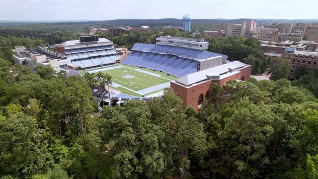 aerial past the moorehead patterson bell tower towards kenan memorial stadium on the unc chapel hill campus in chapel hill nc, north carolina