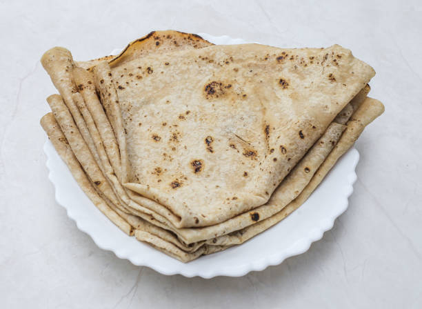 tawa chapati roti served in plate isolated on table top view of indian and pakistani spicy food tawa chapati roti served in plate isolated on table top view of indian and pakistani spicy food One Chapati stock pictures, royalty-free photos & images