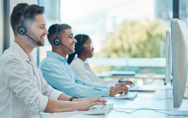 istock Man, call center and customer service team on computer, online support or workers at the office with headset. Crm, consultants and telemarketing agents consulting at workplace or company workspace. 1454435523
