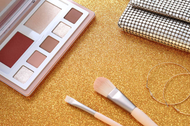 istock Eyeshadow palette makeup brashes and purse on shiny backgrond 1454436945
