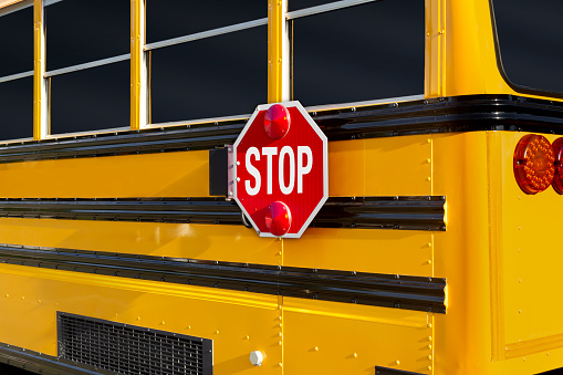 Stop sign at the rear part of a school bus