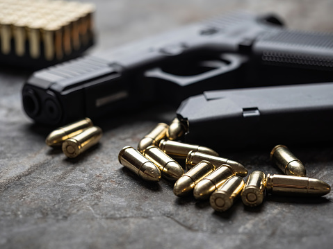 An automatic pistol handgun with a gun safe and shooting equipment.
