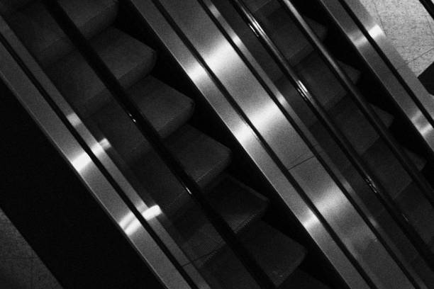 istock Escalators in a Building. Monochrome Black and White Tones 1454442250