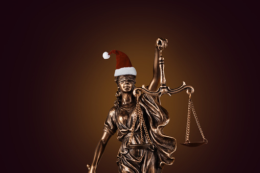 Blind Justitia with Santa hat for Christmas