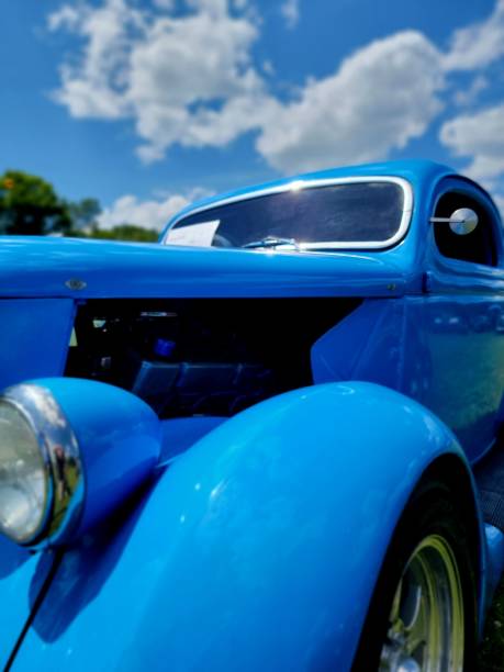 Chester, Nova Scotia, Canada - June 22, 2019 : Customized 1950 Mercury with chopped roof at annual Graves Island Car Show at Graves Island Provincial Park, Chester, Nova Scotia Canada. A lady sits in the cars passenger seat,