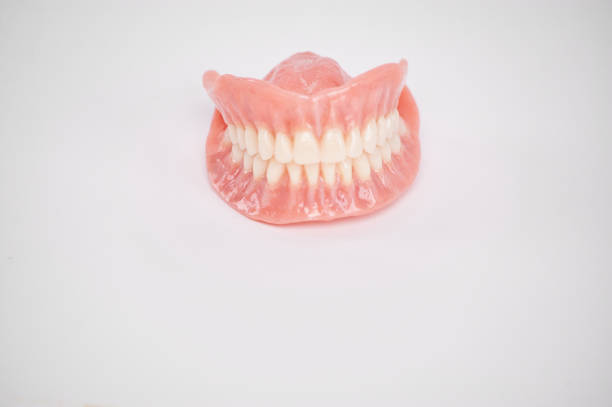 istock Dental prostheses on a white background. Beautiful teeth ceramic press ceramic crowns and veneers. 1454451489