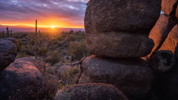 Beautiful sunrise illuminates boulders near Granite Mountain in The McDowell Sonoran Preserve stock photo