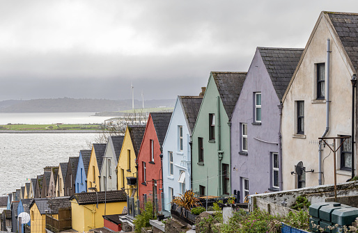 A row of colorful houses on a steep hill near the waterfront in Cobh. Ireland.