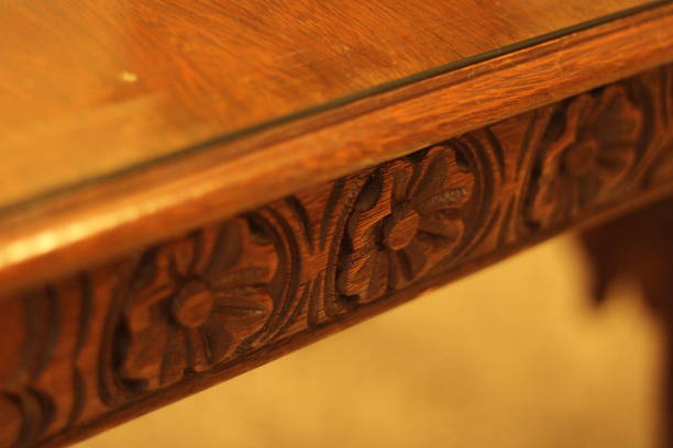 istock Flower Shape Carved on a Wooden Table 1454456434