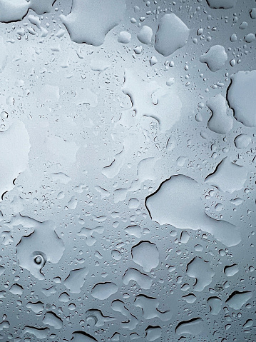 A photo of water droplets from rain on a glass window