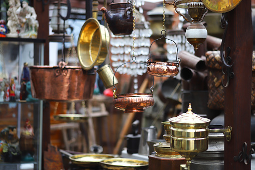 Various antiques, old vintage objects and furniture for sale at a flea market.