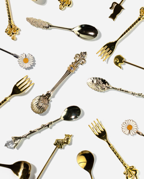 istock Pattern of golden dessert spoons and forks on white background top view 1454458621