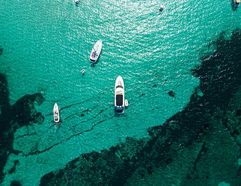 The several boats floating in the clear water