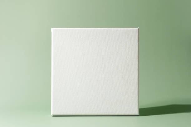istock Mockup poster. Blank canvas frame on minimalistic green background 1454460604
