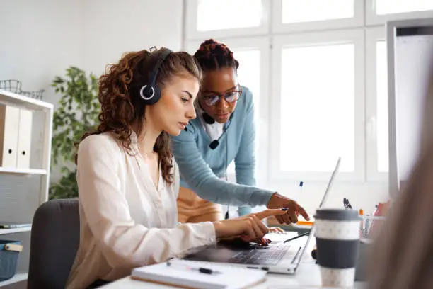 Photo of Female coworkers working together in small offfice