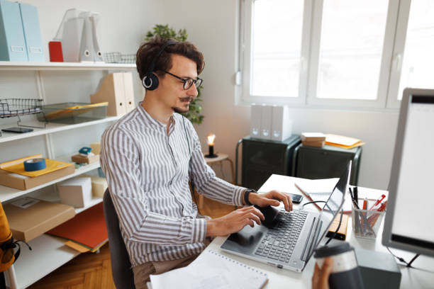 istock Young handsome well dressed man working in call center 1454461308
