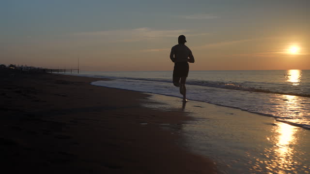 young man running on the beach