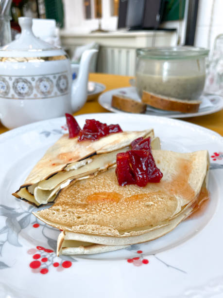 istock Pancakes with strawberry jam on a white plate 1454461797