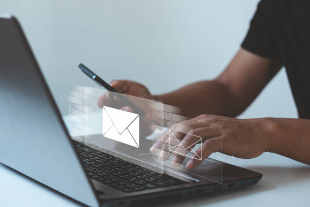 istock Businessman hands using Laptop computer typing on keyboard and surfing the internet on office table with email icon, email marketing concept, send e-mail or newsletter, online working internet network 1454462144