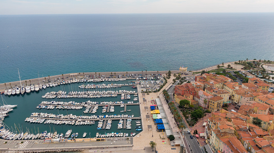 Aerial view on coast, marina and buildings in old Town Menton, France. Drone photo. High angle view of town