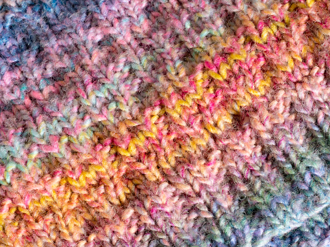 Hand knitted multi coloured patterned background