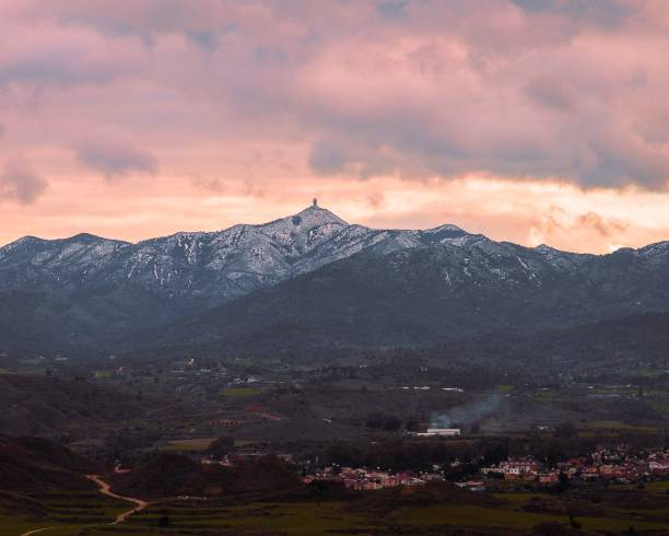 istock Scenic landscape with snow-covered mountains under pink sky 1454469347