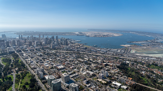 An aerial shot of the cityscape of downtown San Diego, California, surrounded by the ocean