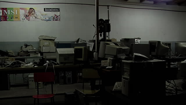 Stack of Electronics Computer Waste in Dark Room, Discarded Electronics in Stacked in Dark Room.