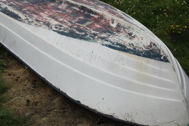 istock Old wooden boat turned on the earth 1454474323