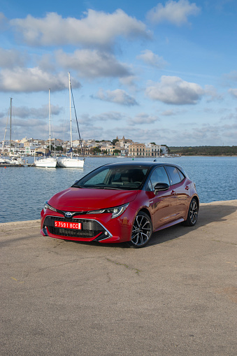 Portocolom, Spain - 18th February, 2019: Toyota Corolla hybrid car stopped on a public parking. The Corolla is the most popular car model in the world.